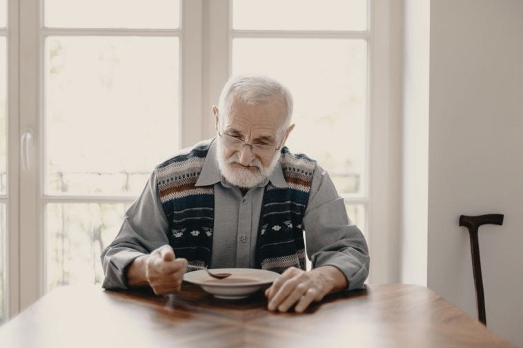 Senior man eating alone Senior man eating alone