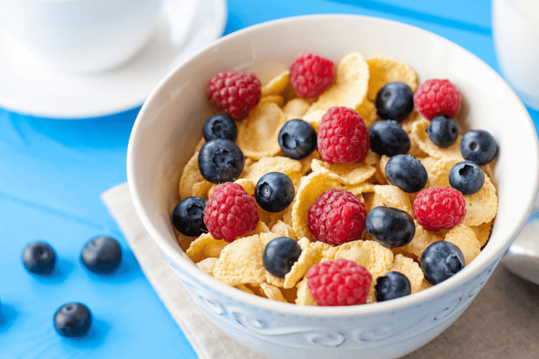 Corn-based breakfast cereal with raspberries and blueberries