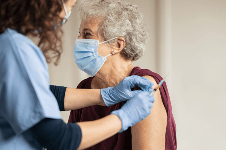 CKD Checklist: Doctor giving vaccine senior woman