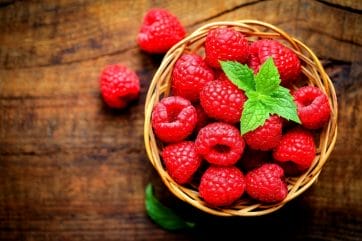 raspberries in a small basket