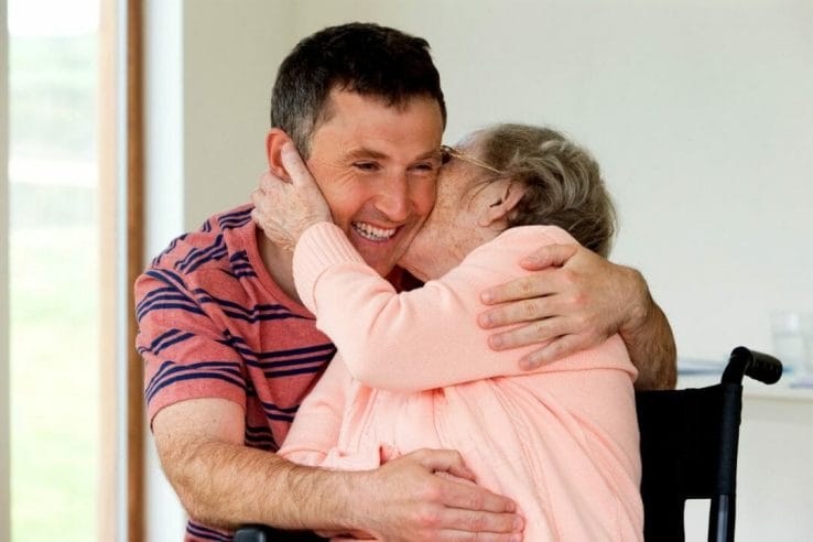 old female kissing an adult male on the cheeks and in Family members as Informal Caregivers (2) old female kissing an adult male on the cheeks and in Family members as Informal Caregivers (2)
