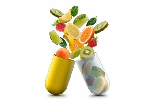fruits inside a capsule showing vitamins