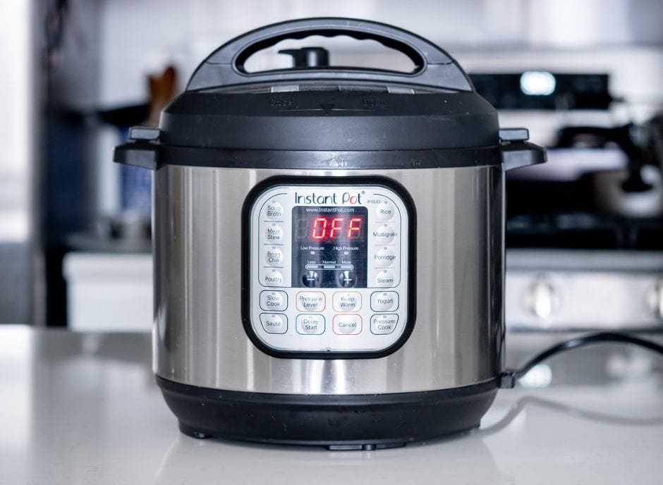 A stainless steel instant pot sitting on a kitchen counter.
