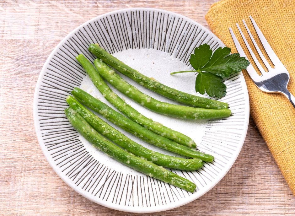 Green beans on a plate with a fork.