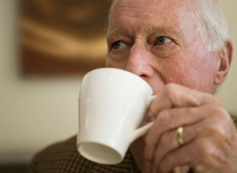 A man drinking a cup of coffee.