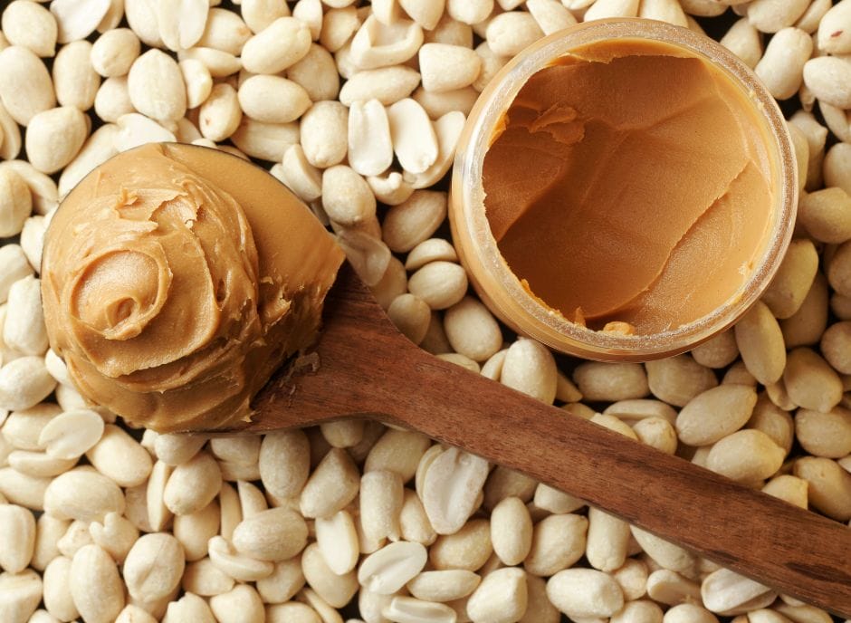 Peanut butter on a wooden spoon, perfect for a renal diet.