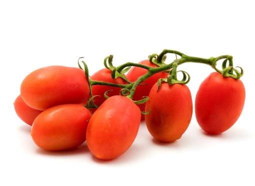 A bunch of red tomatoes on a white background.