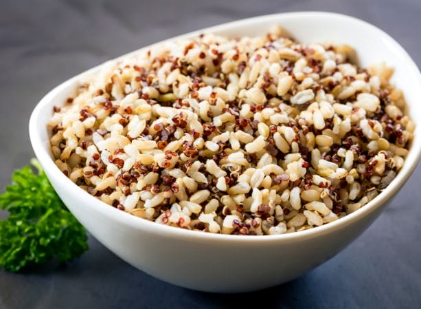 Quinoa in a white bowl, promoting its benefits for kidney health.