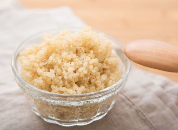 A bowl of brown rice with a wooden spoon, perfect for promoting kidney health.