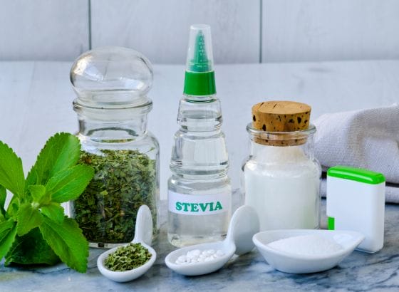 Stevia and other ingredients displayed on a marble table.