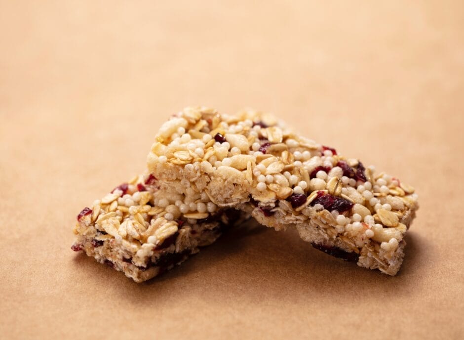 Cranberry granola bars on a brown background.