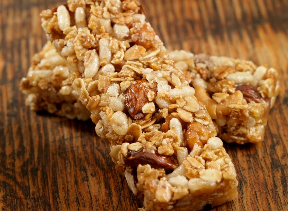 Two granola bars on a wooden table.